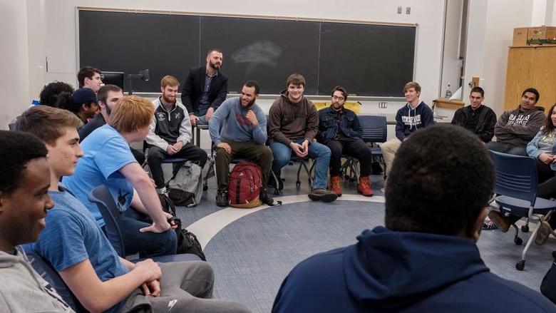 Students sitting in a circle in a classroom